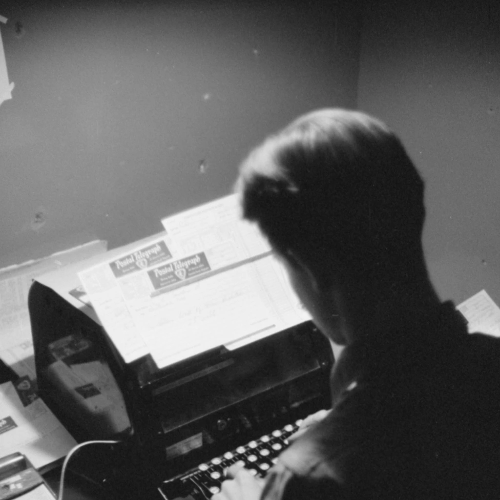 Event Listing Picture of a person typing on a typewriter.